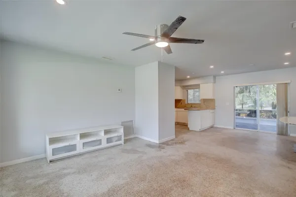 a view of a livingroom with a ceiling fan and window