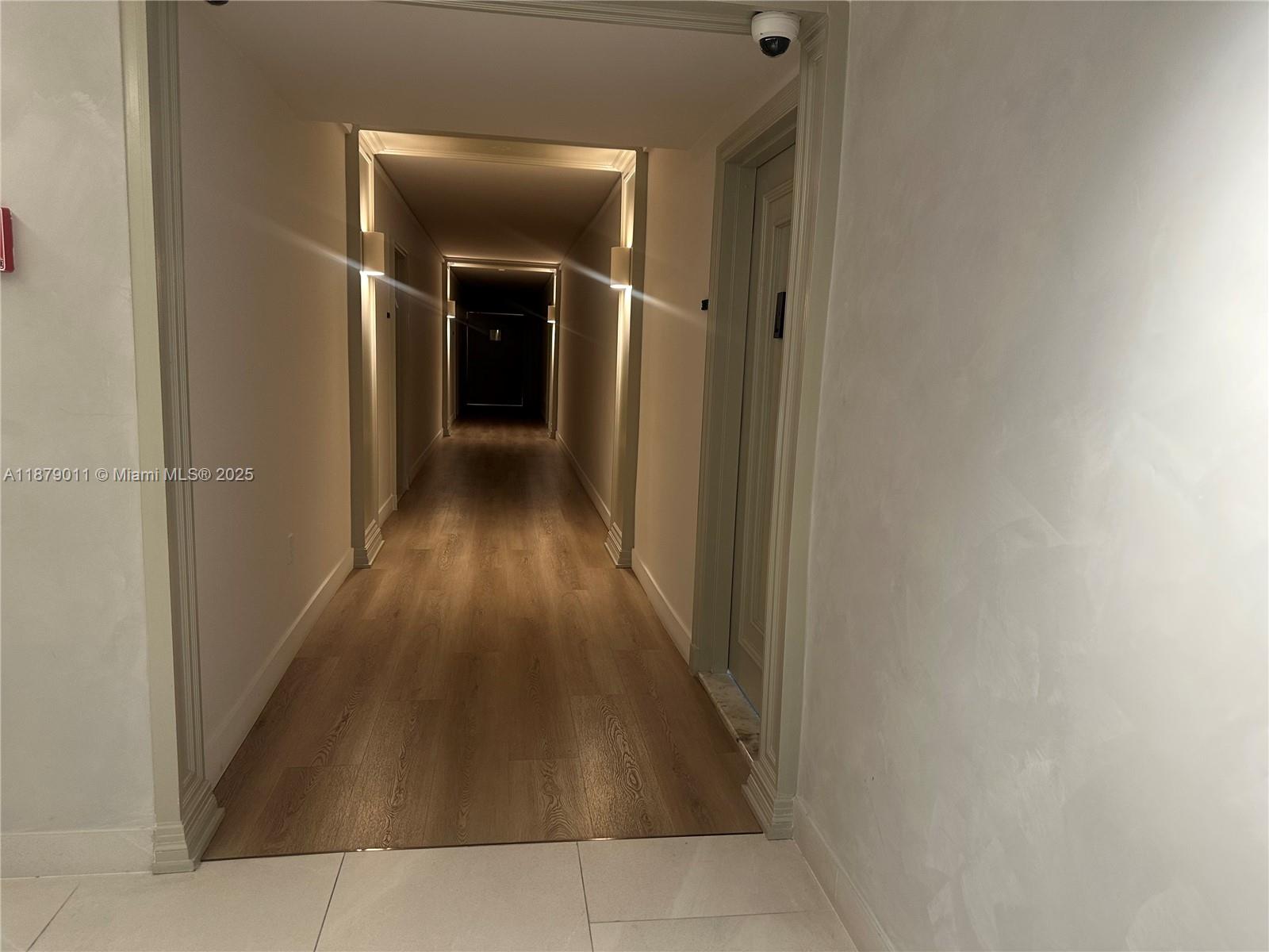 5415 Collins Avenue, Unit 302A Miami Beach, FL 33140 - Photo 17 of 20 a view of hallway with wooden floor