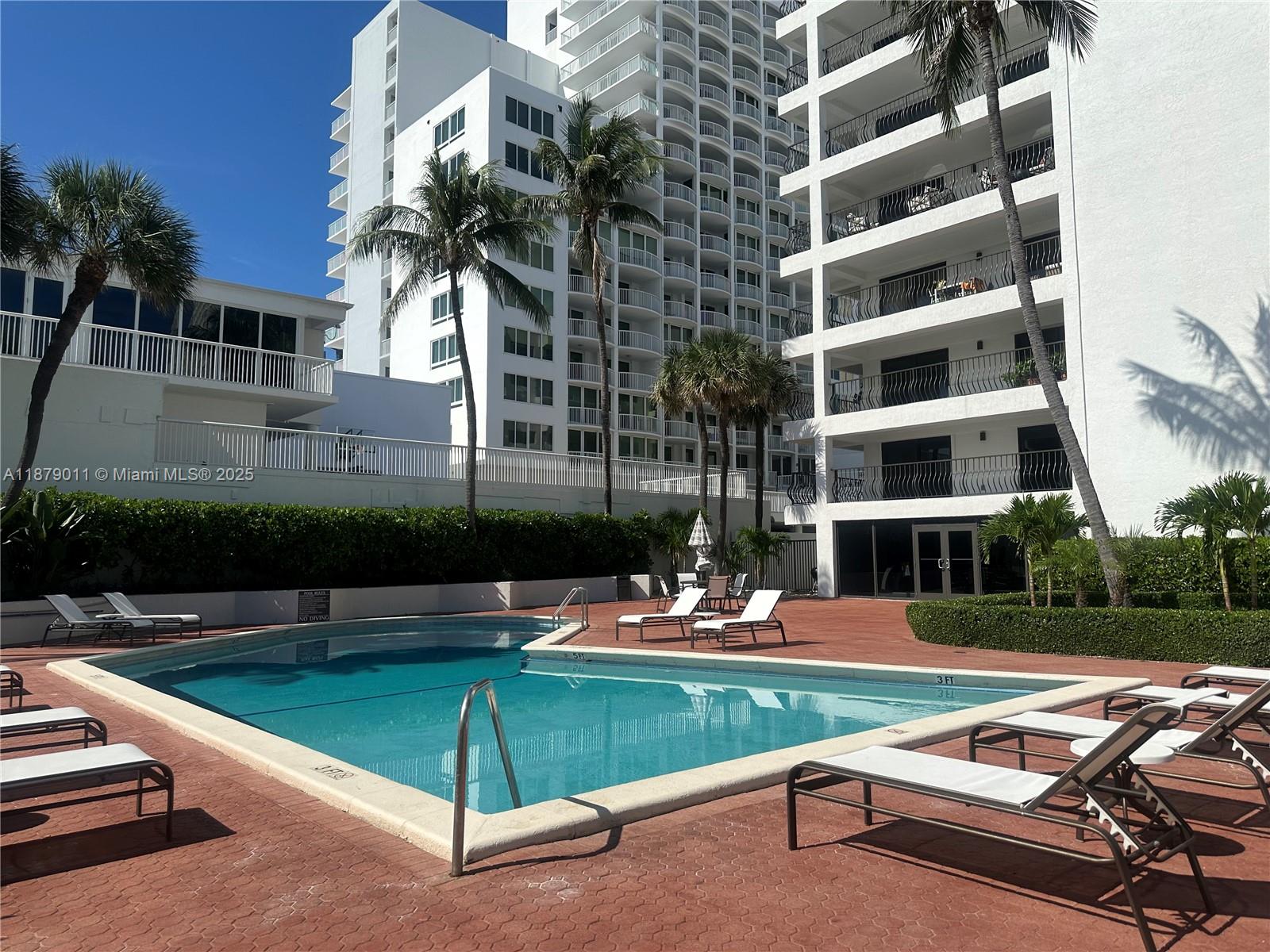 5415 Collins Avenue, Unit 302A Miami Beach, FL 33140 - Photo 2 of 20 a view of a swimming pool with a lounge chairs