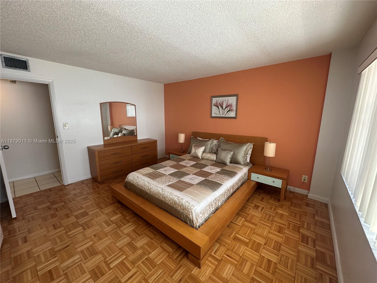 5415 Collins Avenue, Unit 302A Miami Beach, FL 33140 - Photo 9 of 20 a living room with a bed and a couch