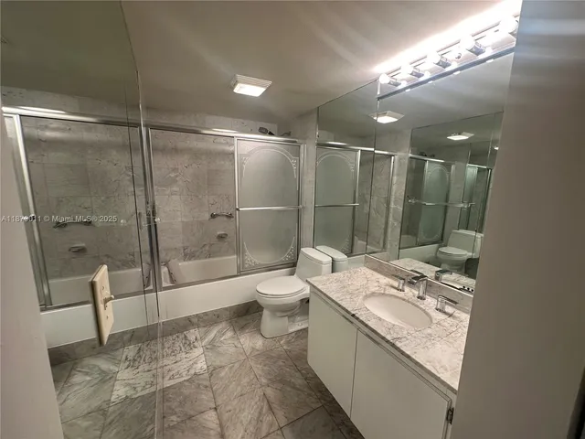 a bathroom with a toilet and a mirror