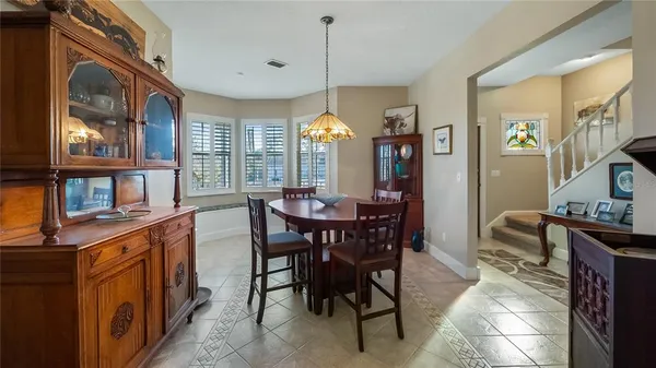 a view of a dining room with furniture and window