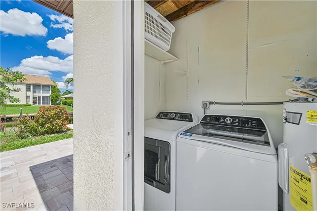 a room with furniture a refrigerator and cabinets