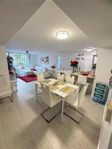 a living room with lots of furniture and kitchen view