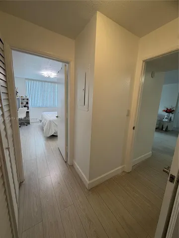 a bedroom with a bed and a large mirror