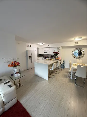 a kitchen with stainless steel appliances a stove a sink a refrigerator and cabinets