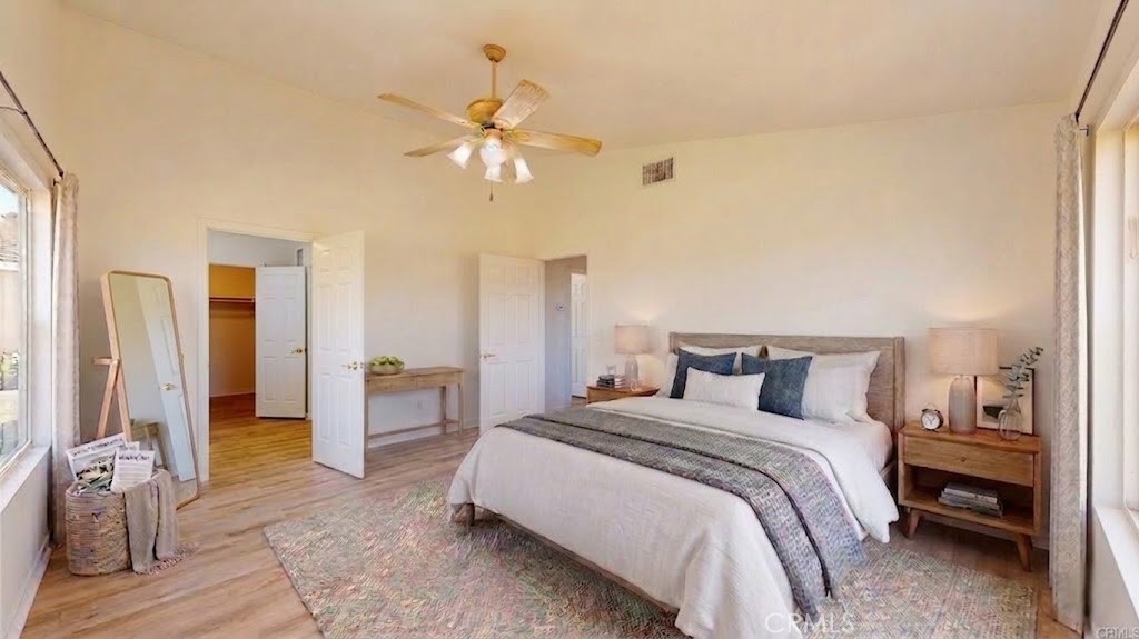 16201 Alta Cresta Avenue Riverside, CA 92508 - Photo 18 of 51 a bedroom with a bed and a chandelier
