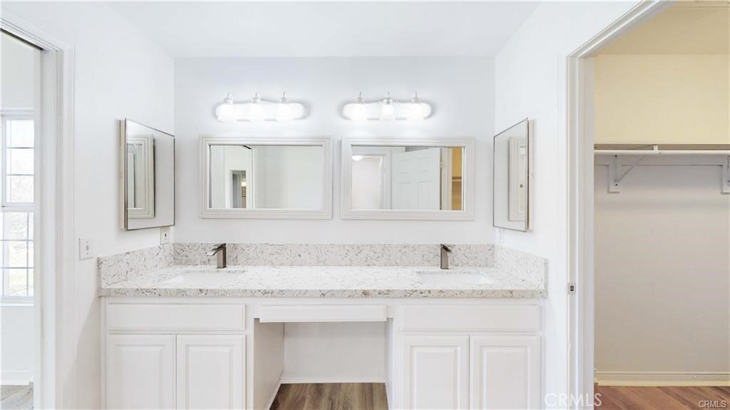 16201 Alta Cresta Avenue Riverside, CA 92508 - Photo 21 of 51 a bathroom with a granite countertop sink and a mirror
