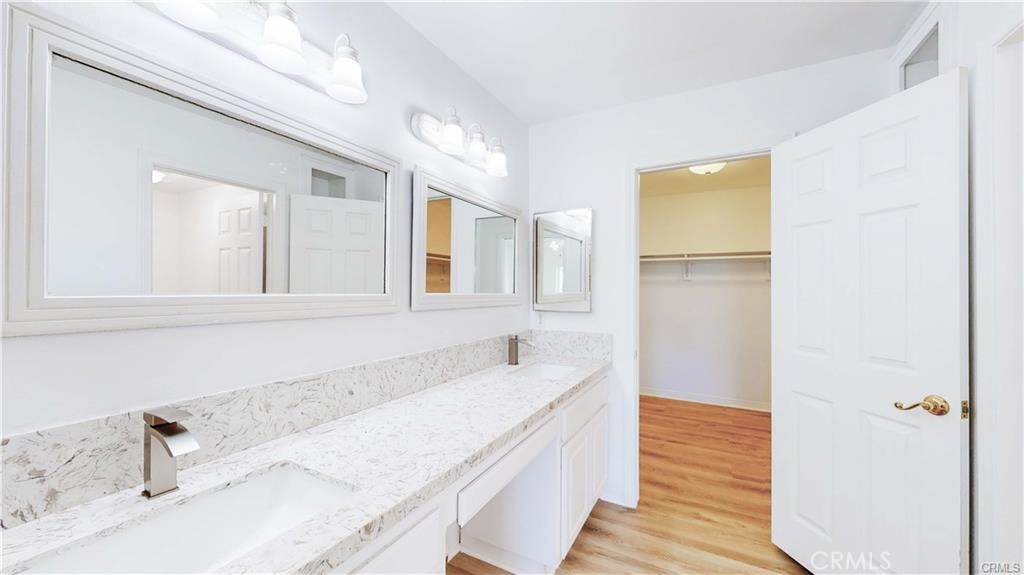 16201 Alta Cresta Avenue Riverside, CA 92508 - Photo 23 of 51 a bathroom with a granite countertop sink and a bathtub