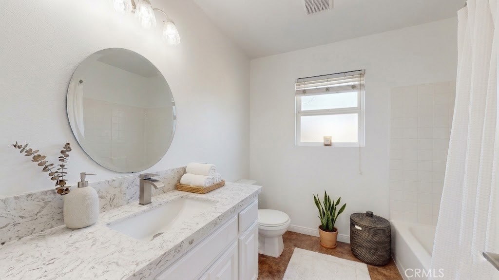 16201 Alta Cresta Avenue Riverside, CA 92508 - Photo 28 of 51 a bathroom with a granite countertop sink and a mirror
