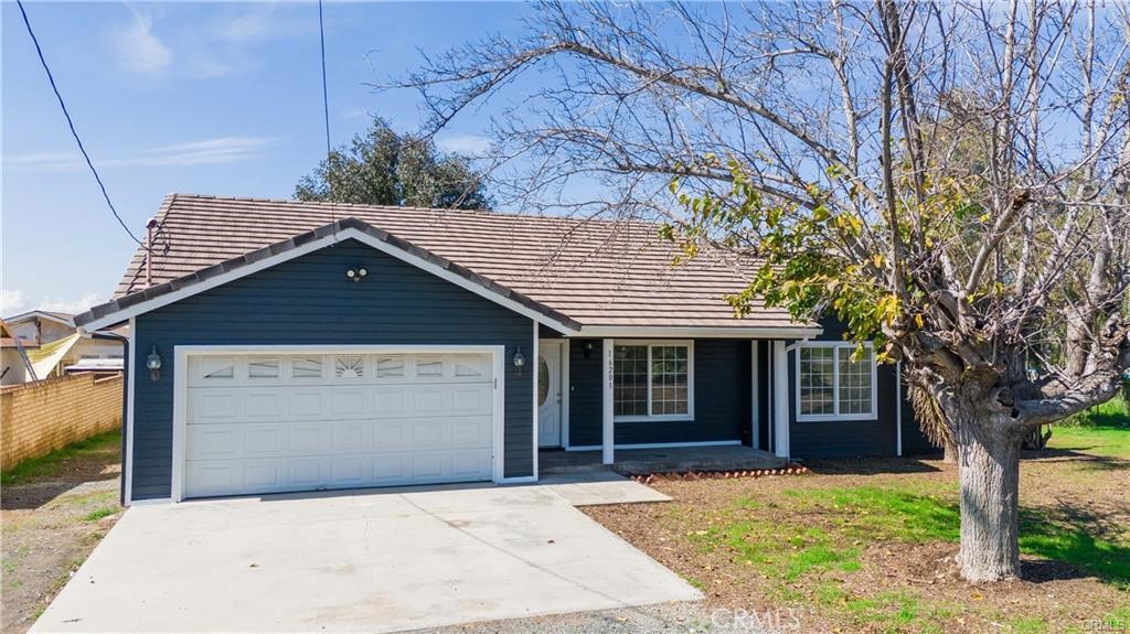 16201 Alta Cresta Avenue Riverside, CA 92508 - Photo 33 of 51 a front view of a house with a garden and trees
