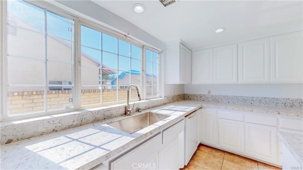 16201 Alta Cresta Avenue Riverside, CA 92508 - Photo 6 of 51 a kitchen with a sink a counter top space and cabinets