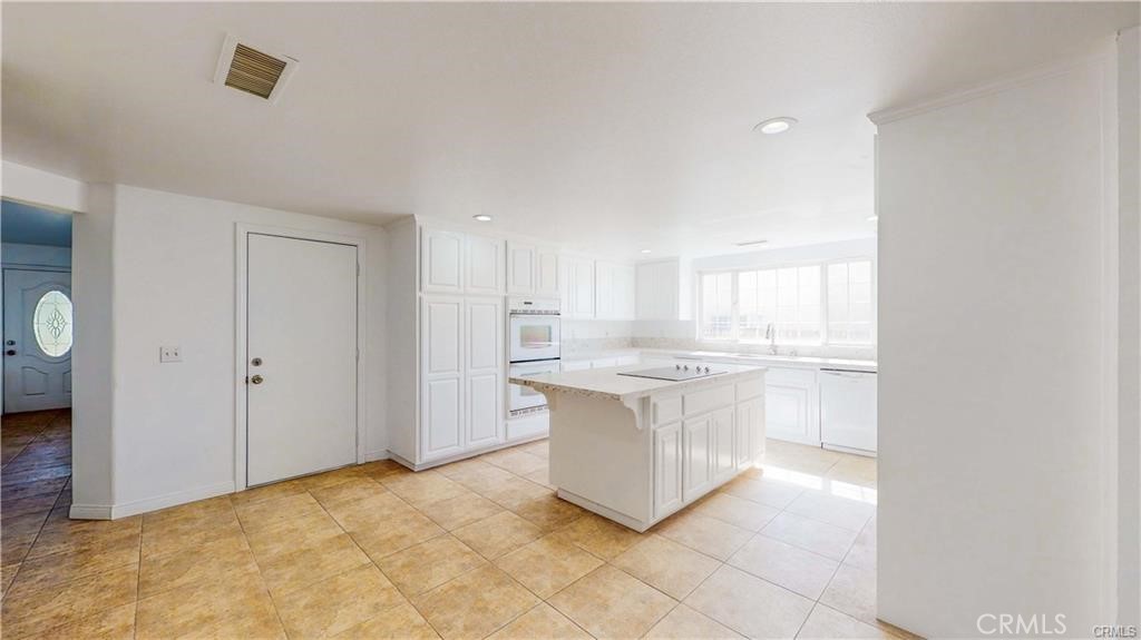 16201 Alta Cresta Avenue Riverside, CA 92508 - Photo 9 of 51 a view of kitchen with granite countertop cabinets and sink