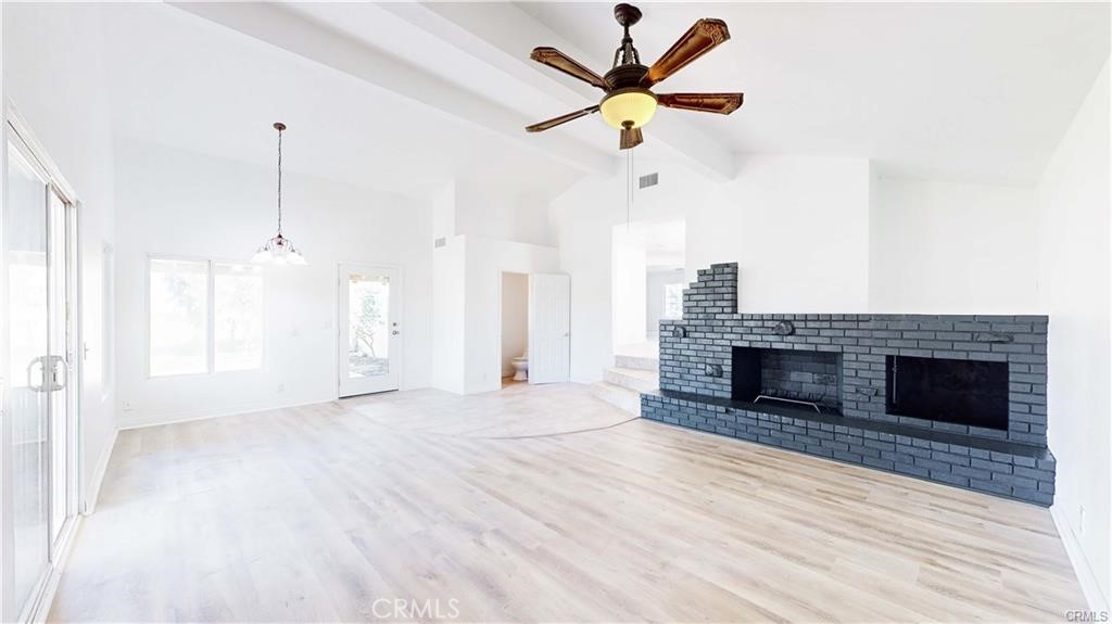16201 Alta Cresta Avenue Riverside, CA 92508 - Photo 10 of 51 an empty room with fireplace and windows