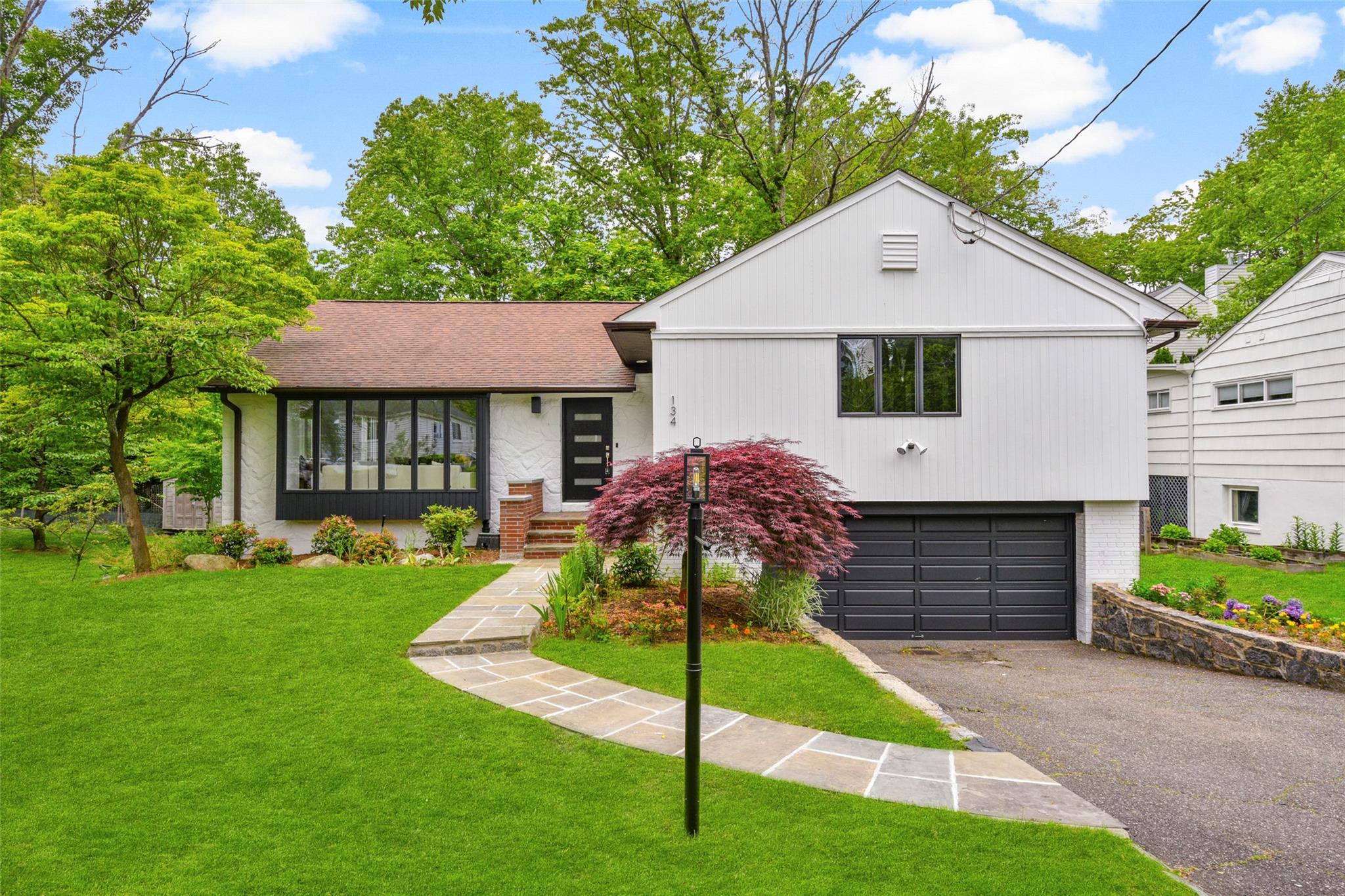 134 Highland Road Scarsdale, NY 10583 - Photo 1 of 1 a front view of a house with a yard and porch