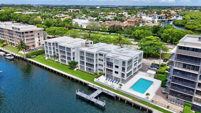an aerial view of a house with a garden and lake view