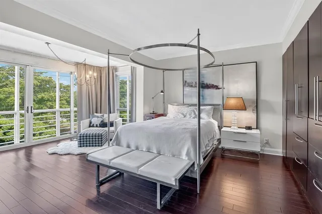 a room with a bed and a large window