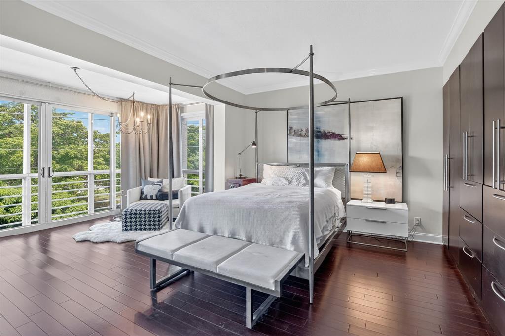 850 Northeast Spanish River Boulevard, Unit 33 Boca Raton, FL 33431 - Photo 12 of 37 a bedroom with a bed and wooden floor