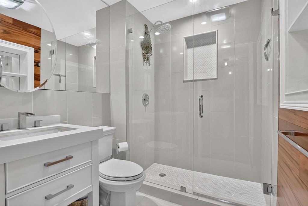 850 Northeast Spanish River Boulevard, Unit 33 Boca Raton, FL 33431 - Photo 17 of 37 a bathroom with a sink a toilet and shower