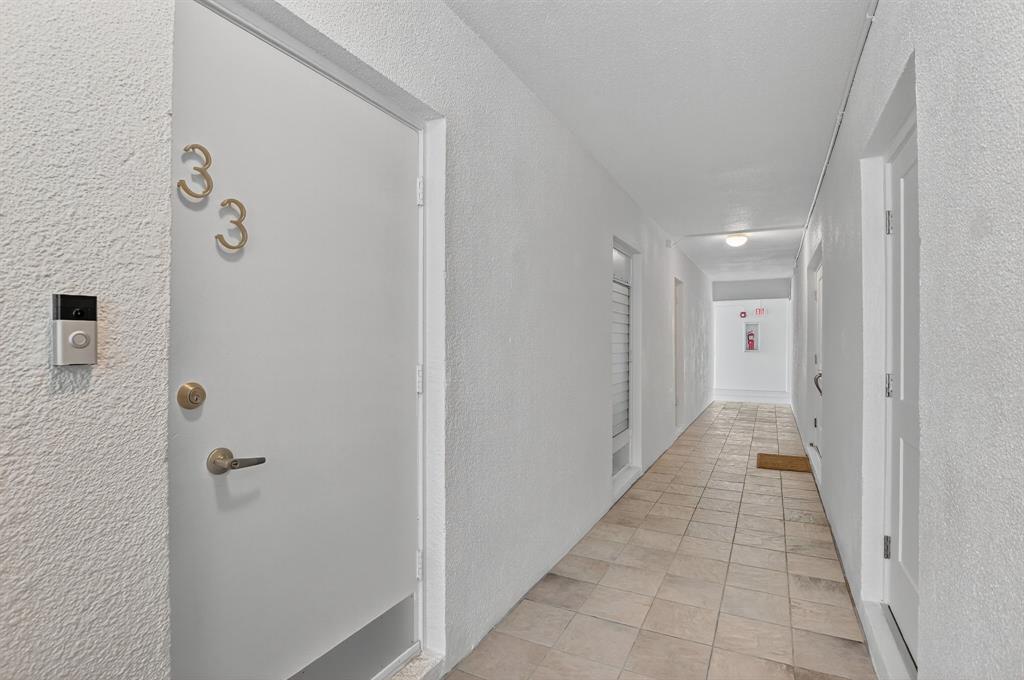 850 Northeast Spanish River Boulevard, Unit 33 Boca Raton, FL 33431 - Photo 21 of 37 a view of a hallway with a white door