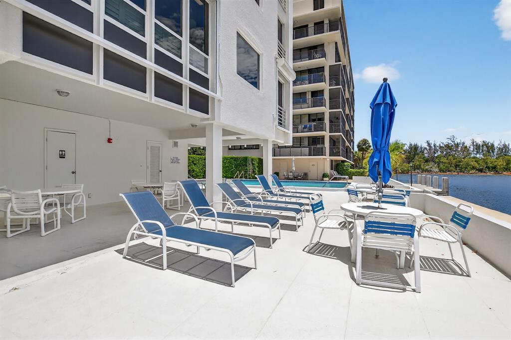 850 Northeast Spanish River Boulevard, Unit 33 Boca Raton, FL 33431 - Photo 25 of 37 a view of a patio with a table and chairs