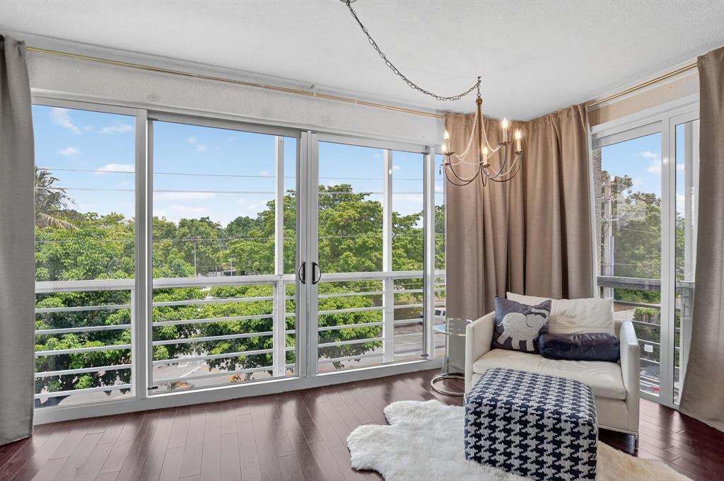 850 Northeast Spanish River Boulevard, Unit 33 Boca Raton, FL 33431 - Photo 26 of 37 a bedroom with furniture and a large window