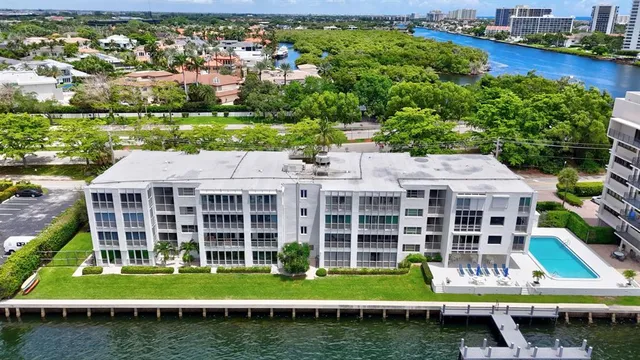 an aerial view of a house with a garden and lake view
