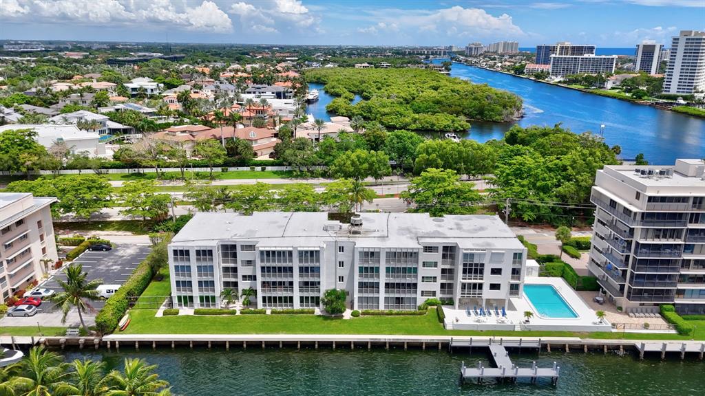 850 Northeast Spanish River Boulevard, Unit 33 Boca Raton, FL 33431 - Photo 28 of 37 an aerial view of a house with a garden and lake view