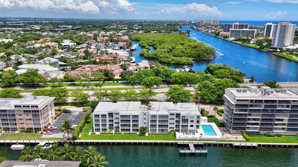 850 Northeast Spanish River Boulevard, Unit 33 Boca Raton, FL 33431 - Photo 29 of 37 an aerial view of a house with a garden and lake view