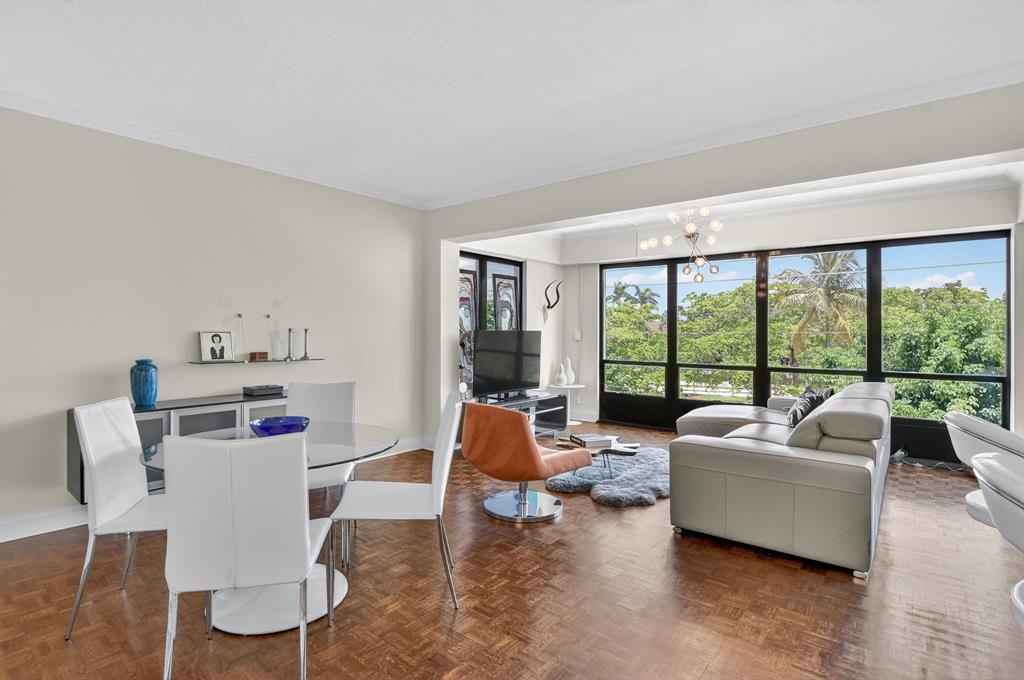 850 Northeast Spanish River Boulevard, Unit 33 Boca Raton, FL 33431 - Photo 3 of 37 a living room with furniture and a large window