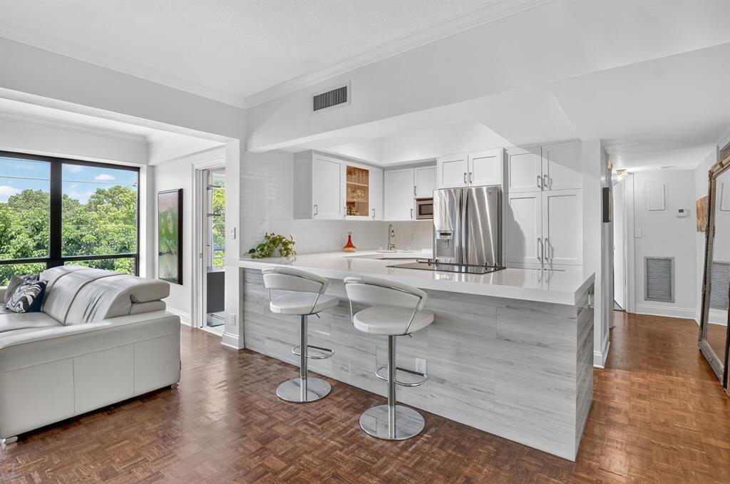 850 Northeast Spanish River Boulevard, Unit 33 Boca Raton, FL 33431 - Photo 4 of 37 a living room with furniture and a large window