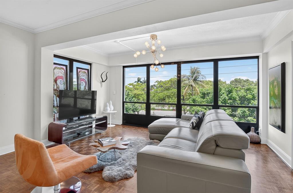 850 Northeast Spanish River Boulevard, Unit 33 Boca Raton, FL 33431 - Photo 5 of 37 a living room with furniture and a large window