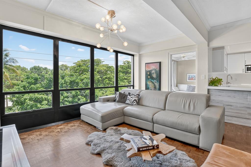 850 Northeast Spanish River Boulevard, Unit 33 Boca Raton, FL 33431 - Photo 6 of 37 a living room with furniture and a large window