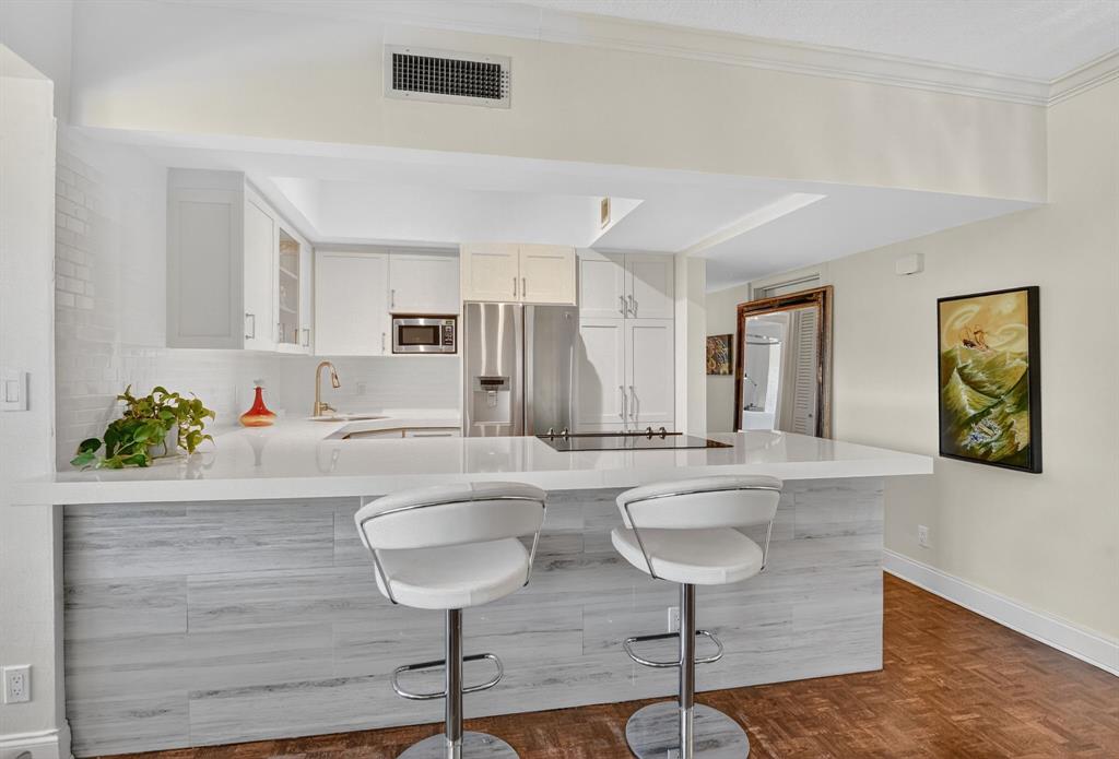 850 Northeast Spanish River Boulevard, Unit 33 Boca Raton, FL 33431 - Photo 9 of 37 a living room with furniture and a table