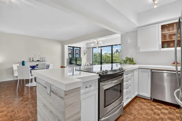 a kitchen with a stove a sink and a refrigerator