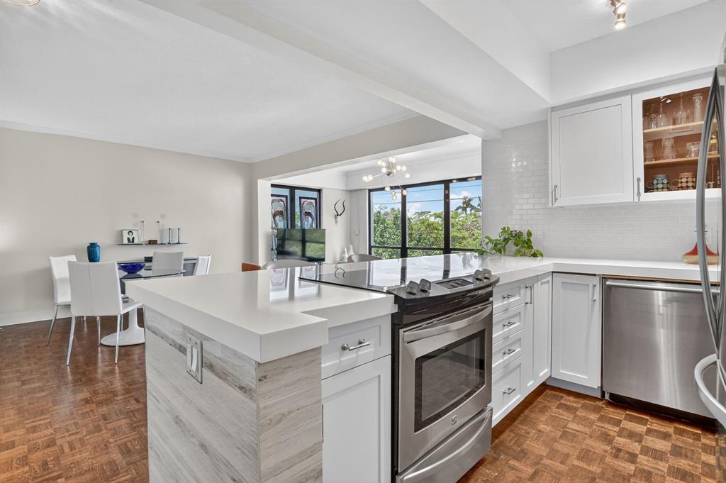 850 Northeast Spanish River Boulevard, Unit 33 Boca Raton, FL 33431 - Photo 10 of 37 a kitchen with a stove a sink and a refrigerator