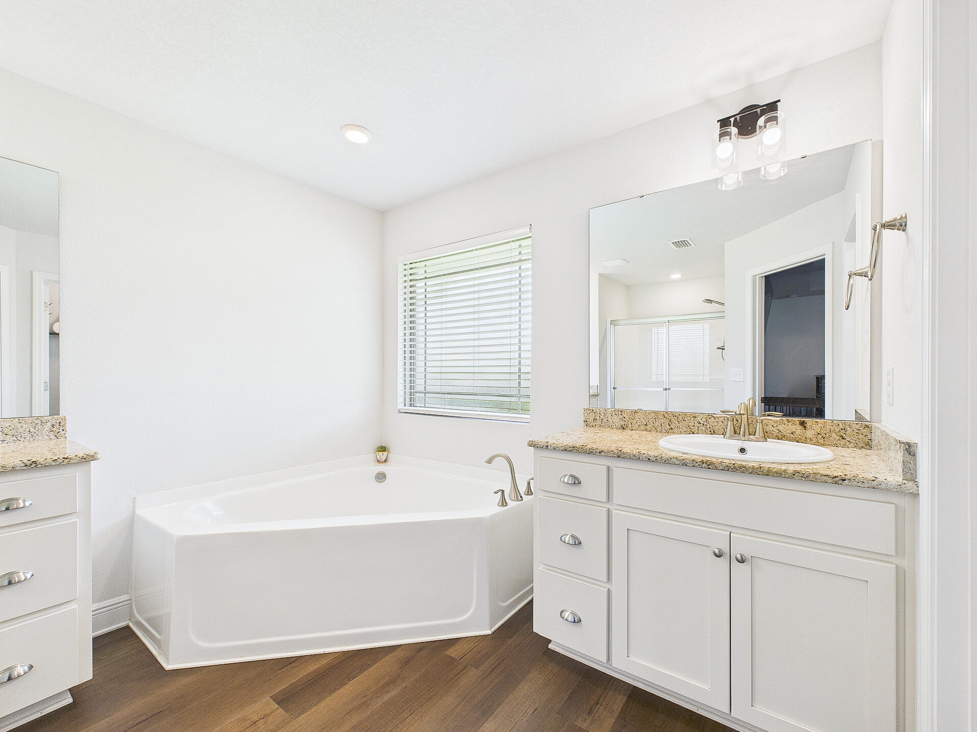 5740 Marigold Loop Crestview, FL 32539 - Photo 27 of 47 a bathroom with a double vanity sink a mirror and a bathtub