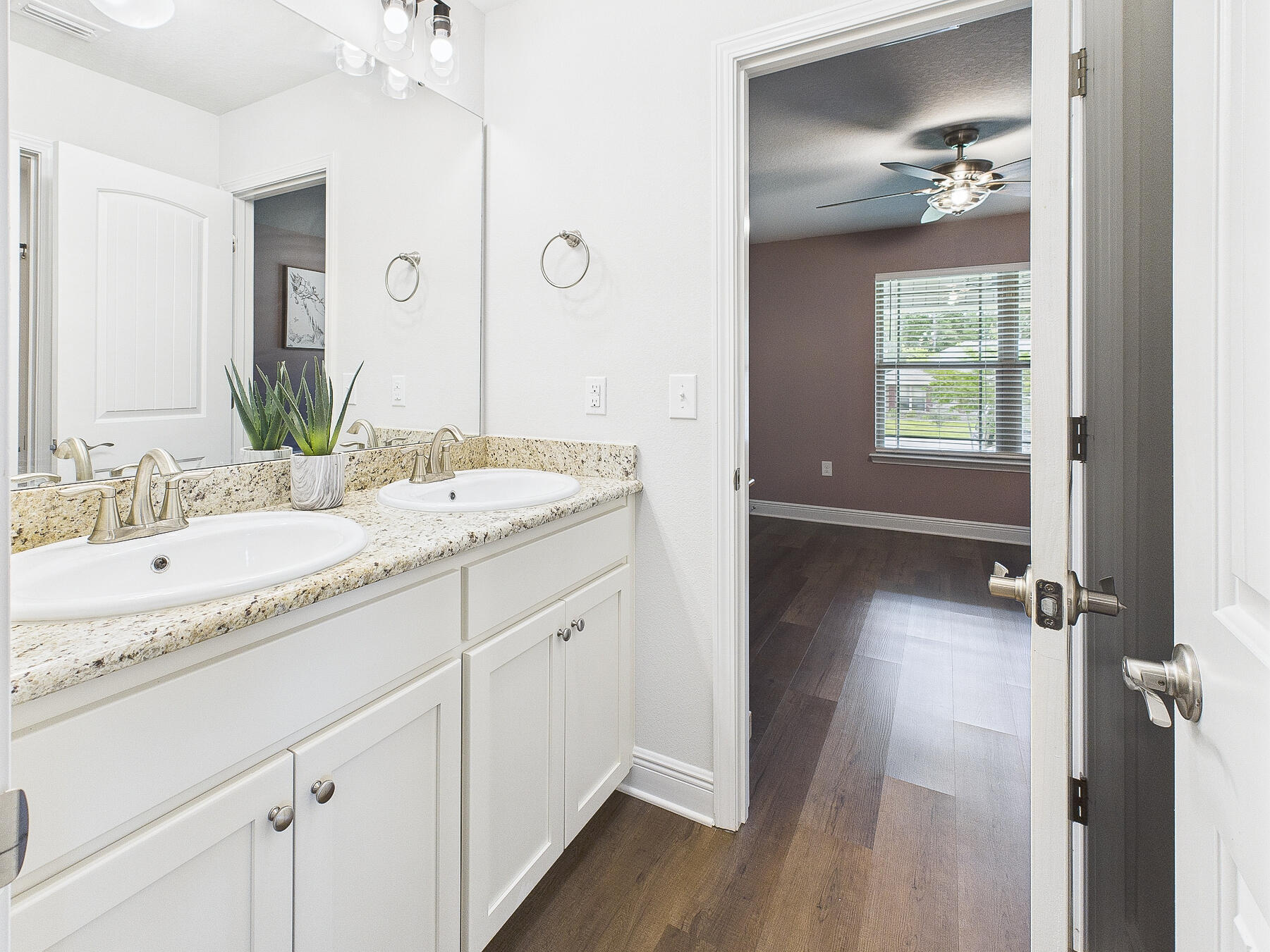5740 Marigold Loop Crestview, FL 32539 - Photo 32 of 47 a bathroom with a granite countertop sink a mirror and a bathtub