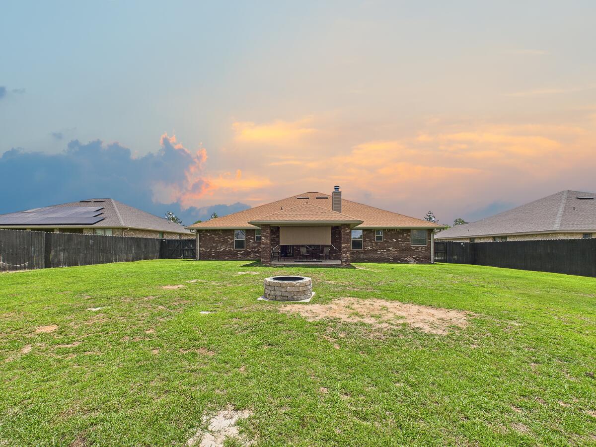5740 Marigold Loop Crestview, FL 32539 - Photo 42 of 47 a view of a house with a big yard and a large tree
