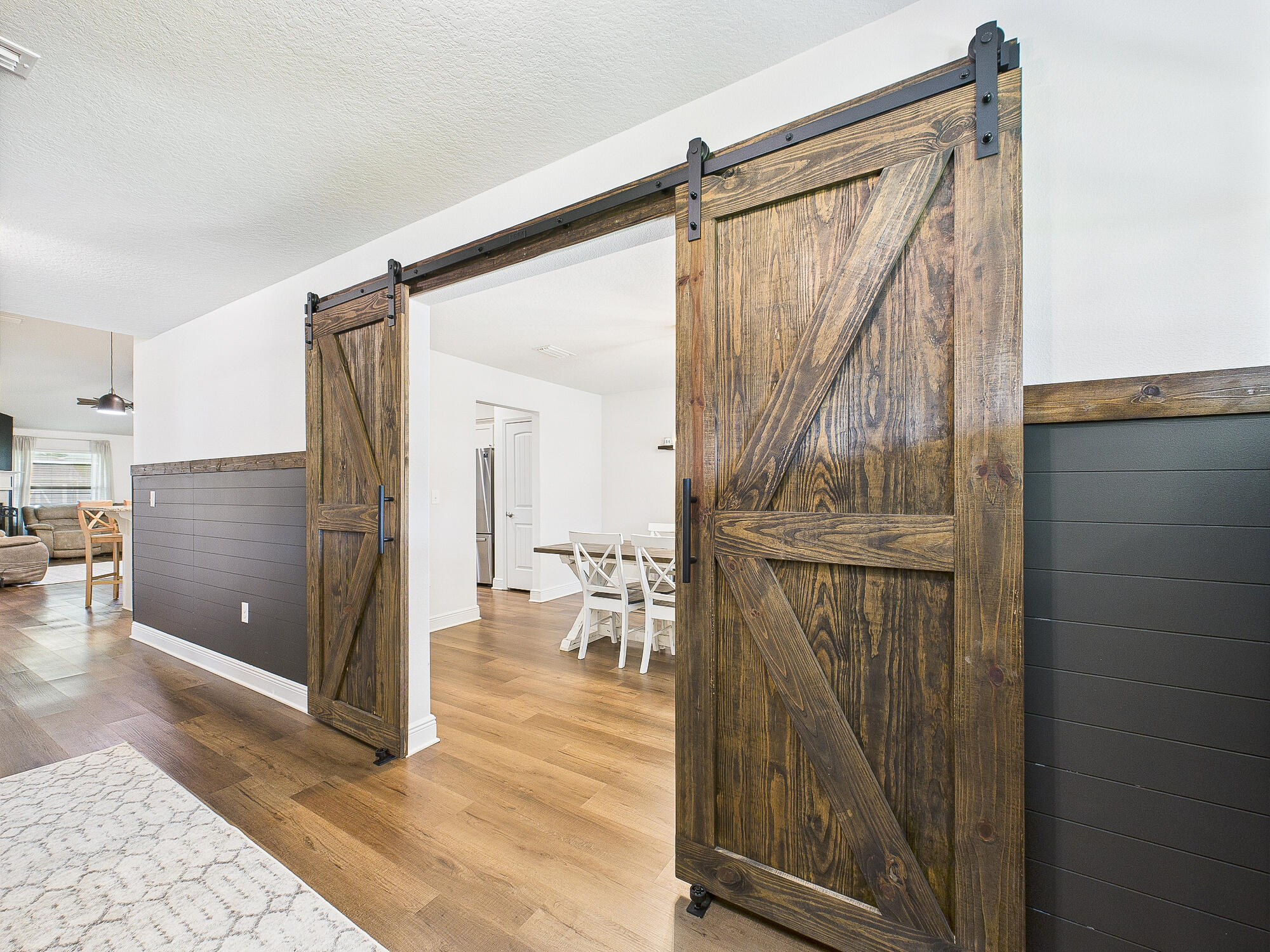 5740 Marigold Loop Crestview, FL 32539 - Photo 6 of 47 a view of a hallway with wooden floor and glass door