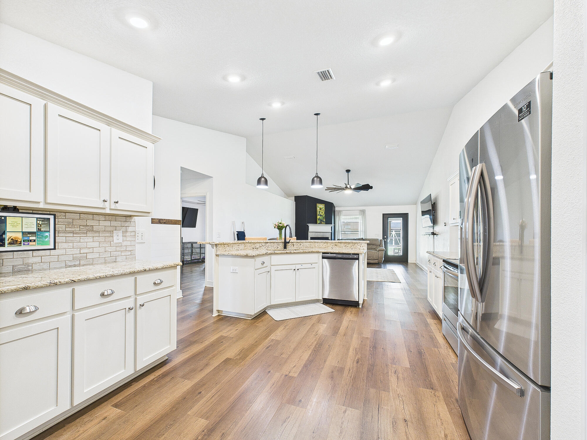 5740 Marigold Loop Crestview, FL 32539 - Photo 9 of 47 a kitchen with white cabinets and stainless steel appliances