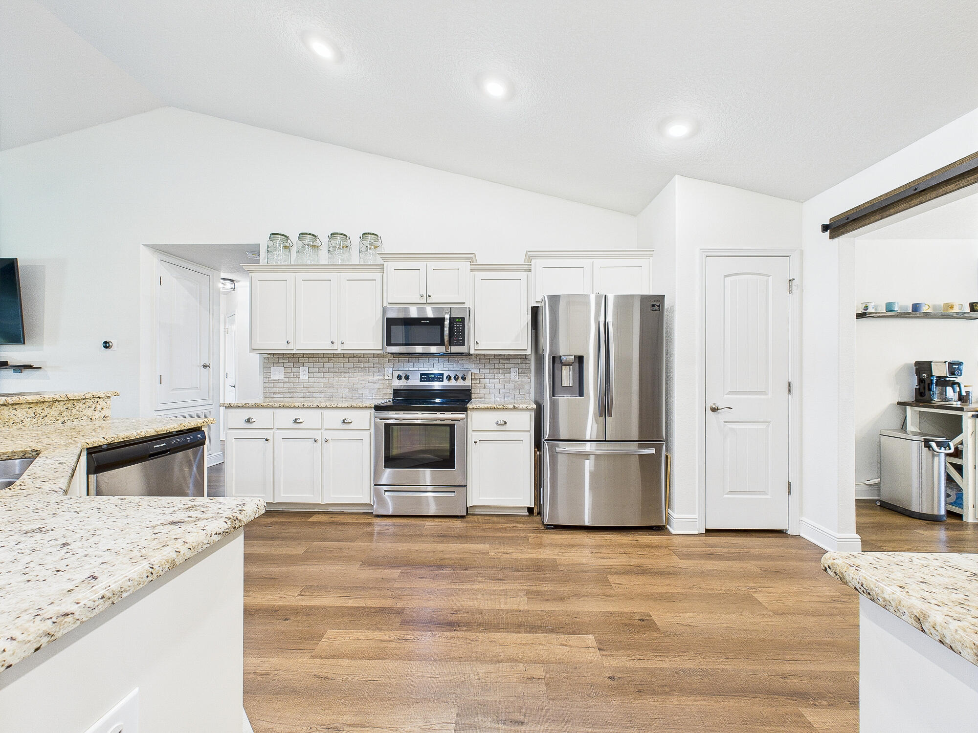 5740 Marigold Loop Crestview, FL 32539 - Photo 10 of 47 a kitchen with granite countertop a refrigerator stove and sink