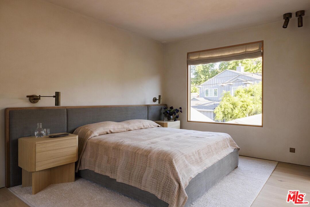 12128 Viewcrest Road Studio City, CA 91604 - Photo 11 of 24 a bedroom with a bed and window