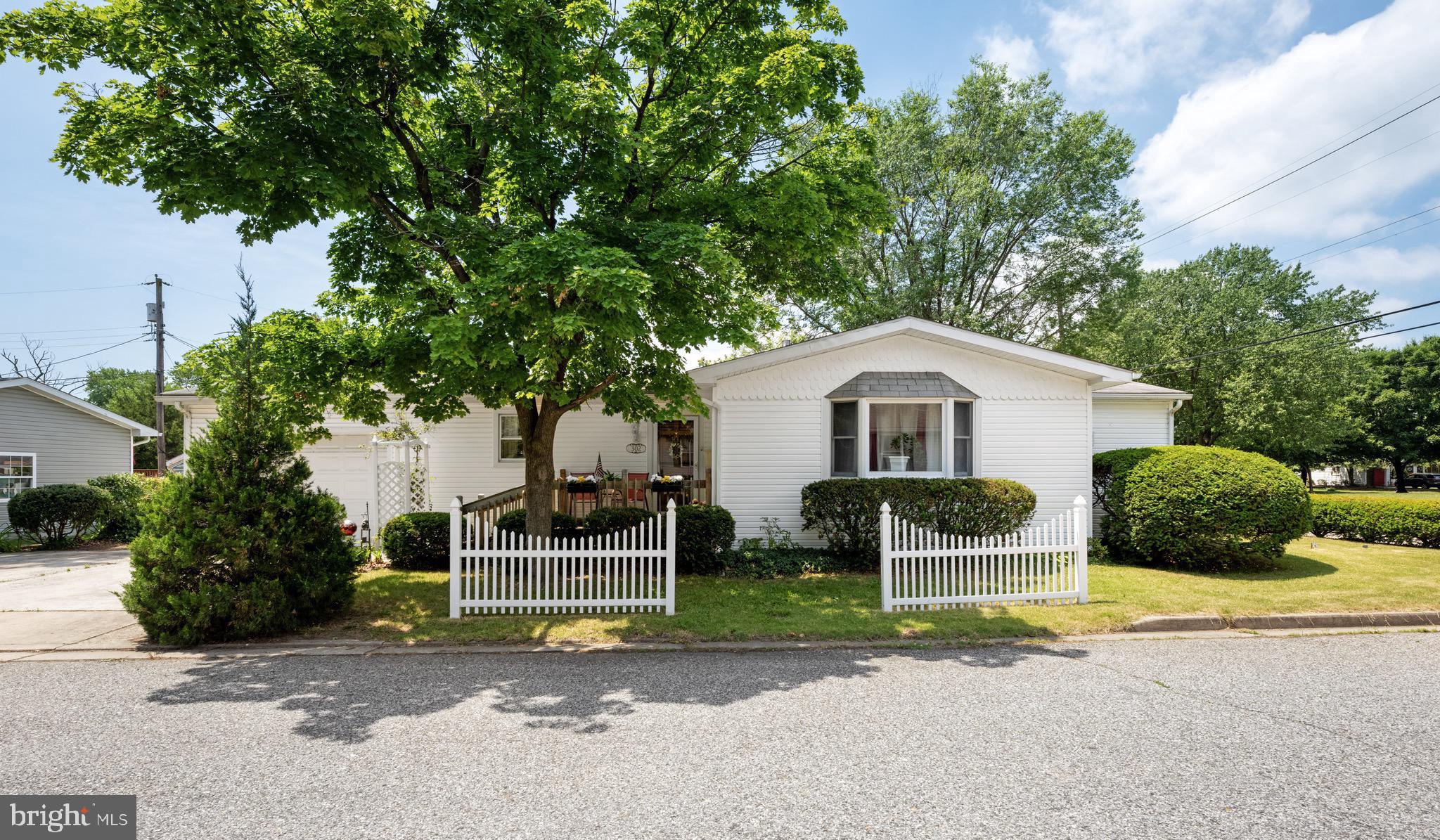 302 Tyler Avenue Carneys Point, NJ 08069 - Photo 1 of 27 a front view of a house with a yard and garage