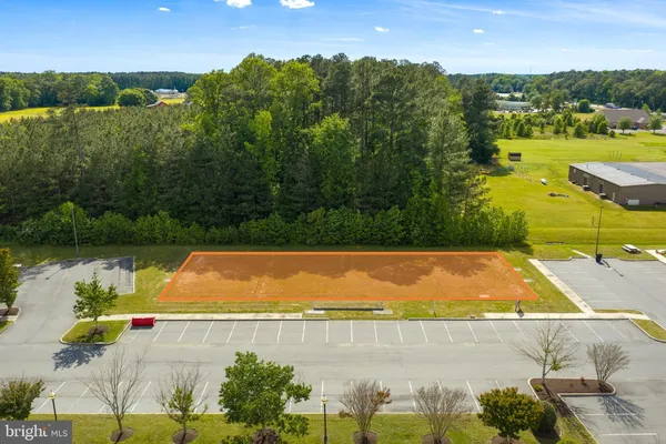 an aerial view of residential houses with outdoor space and swimming pool