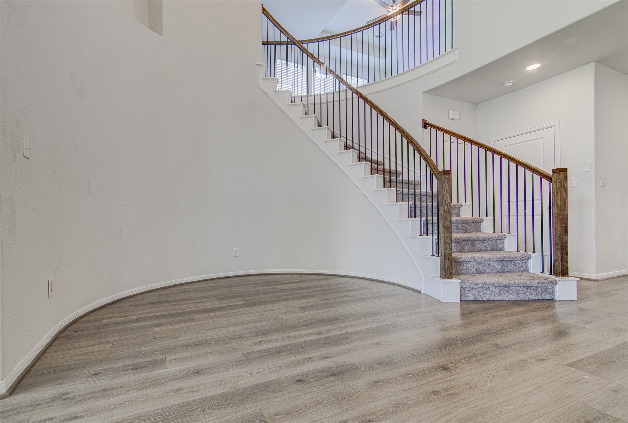 774 Cherrystone Loop Buda, TX 78610 - Photo 9 of 38 A grand, curved staircase with wrought iron balusters makes a striking entry statement.