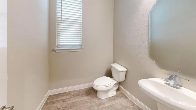 a white toilet sitting next to a white sink