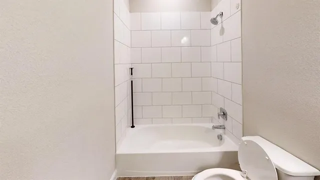 a bathroom with a bathtub and toilet