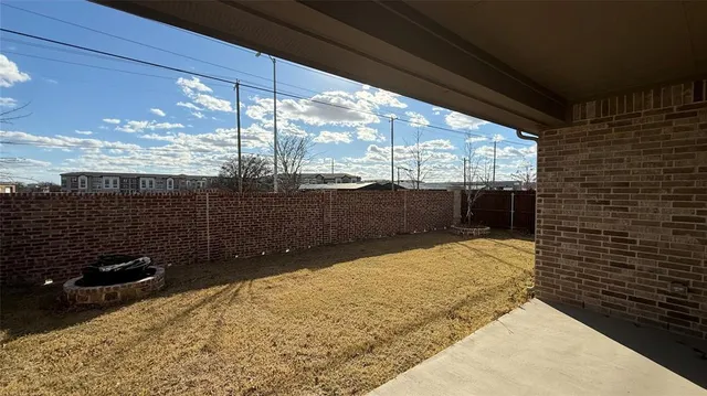 a view of a backyard of the house