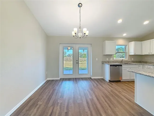 a view of a kitchen with wooden floor and a window